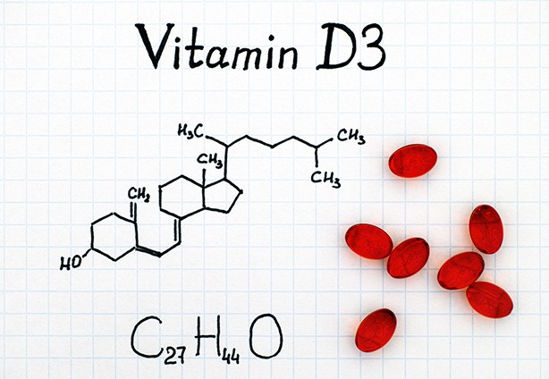 Chemical formula of Vitamin D3 and red pills.