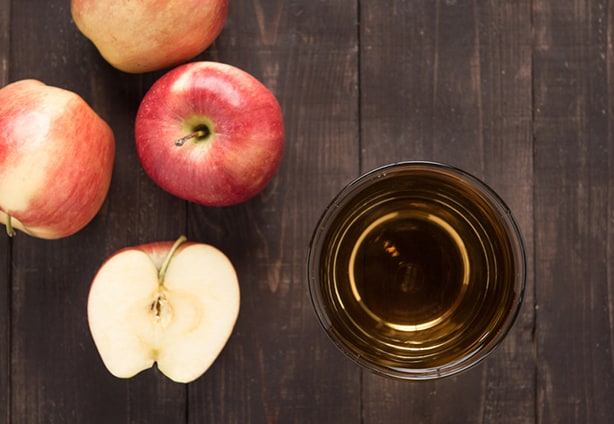 Top view healthy apple juice drink and red apples fruits on wooden background.